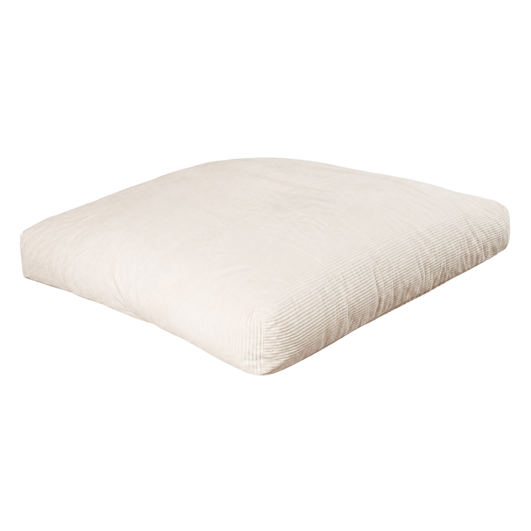 Pouf-lit convertible blanc cassé déplié en lit, surface rembourrée rectangulaire
